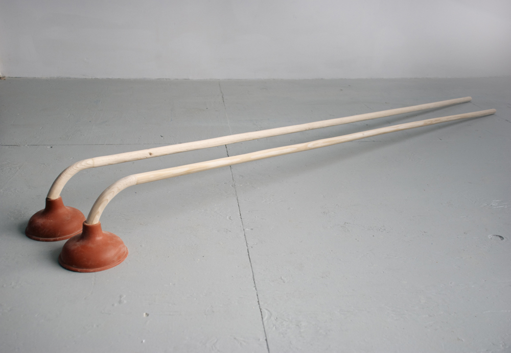 Shoe Store 2011 sculpture by Aaron King wood, plungers 10'' x 86'' x 14'' Shoe Store 2011 sculpture by Aaron King wood, plungers 10'' x 86'' x 14''